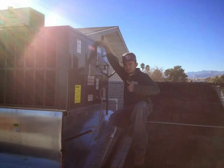 HVAC technician performing HVAC Inspection on a rooftop unit in Picture Rocks